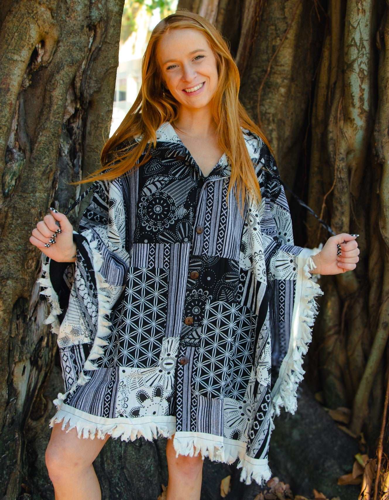 Hand-crafted cotton poncho with coconut shell buttons and unique pattern design.