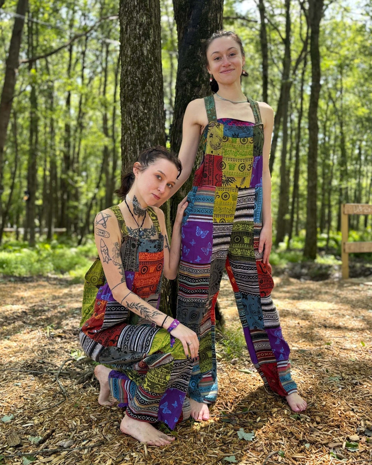 Multi color Ikat patchwork overalls in vibrant patterns worn by two individuals outdoors.