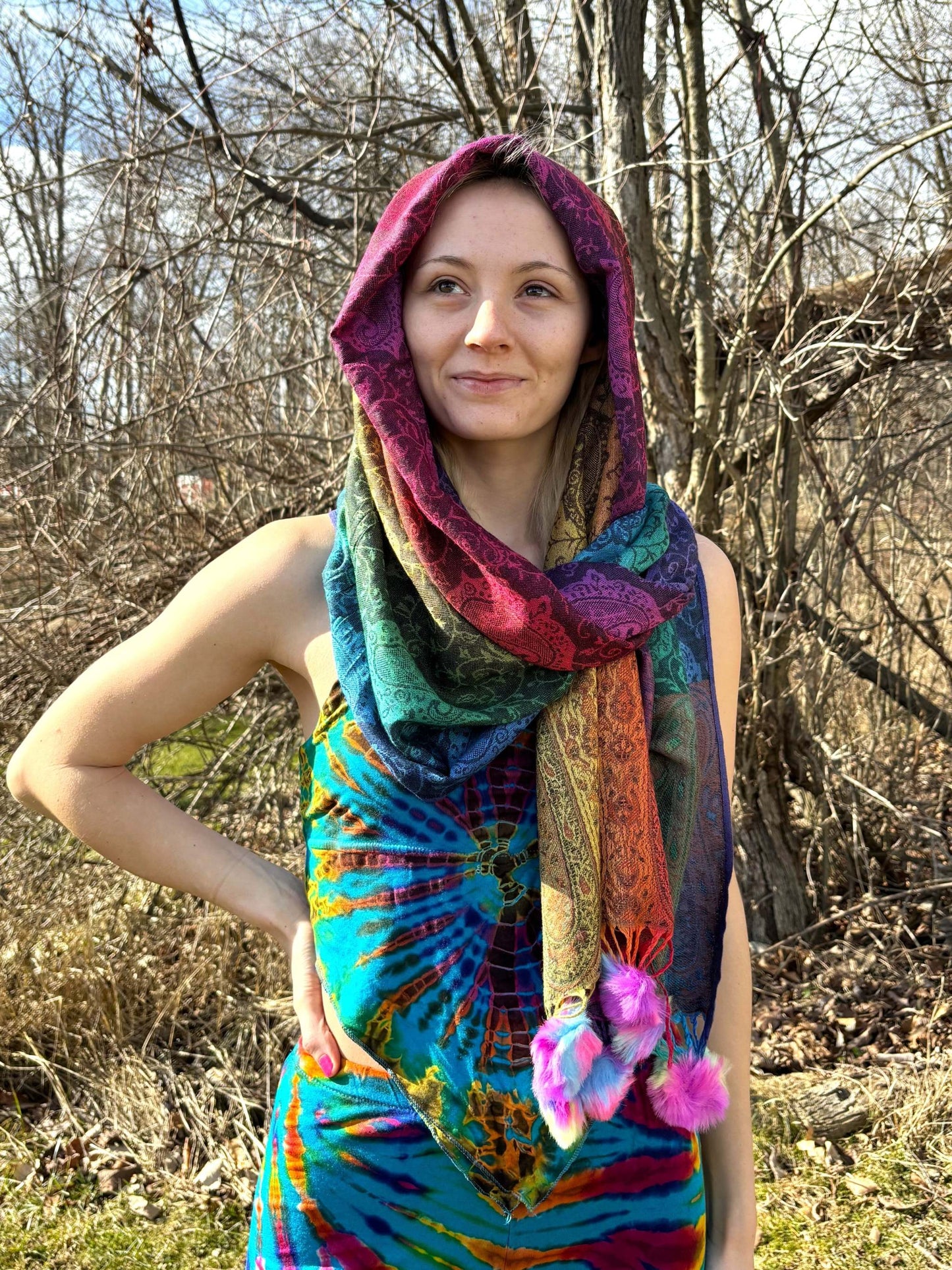 Woman wearing a Rainbow Pom-Pom Pashmina in a forest setting.
