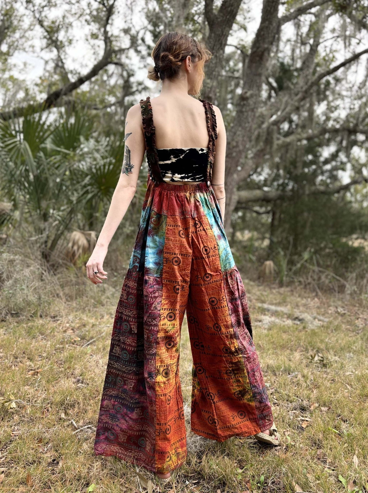 Tye-dye pallazzo overalls with adjustable straps in a colorful pattern, handcrafted in 100% cotton.
