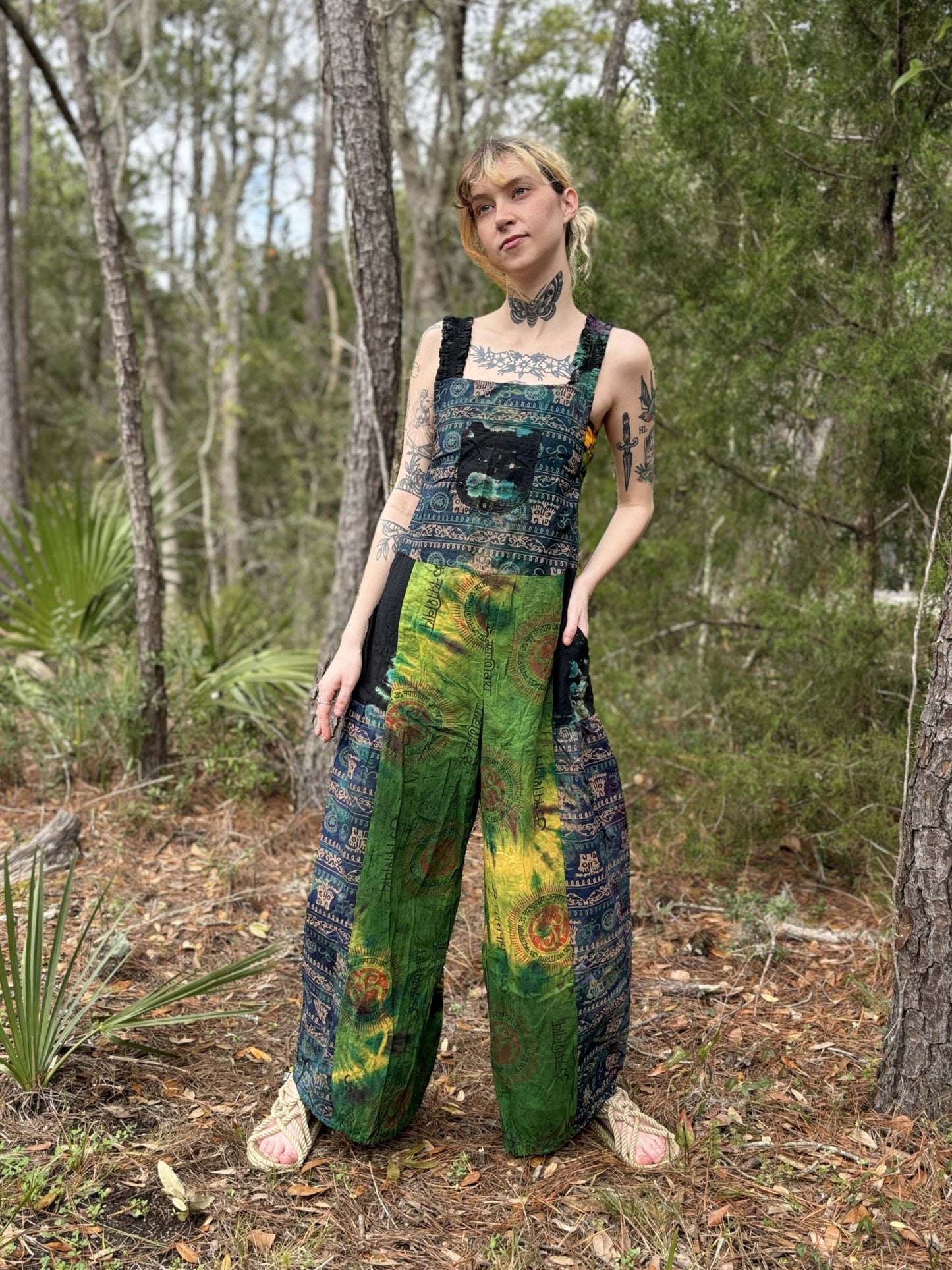 Tie-dye Palazzo overalls with adjustable straps and harem legs in vibrant colors.