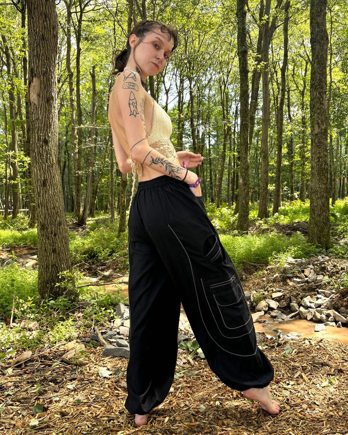 9 pocket harem pants with elastic cuffs and waist, featuring multiple zipper pockets, ideal for outdoor activities.