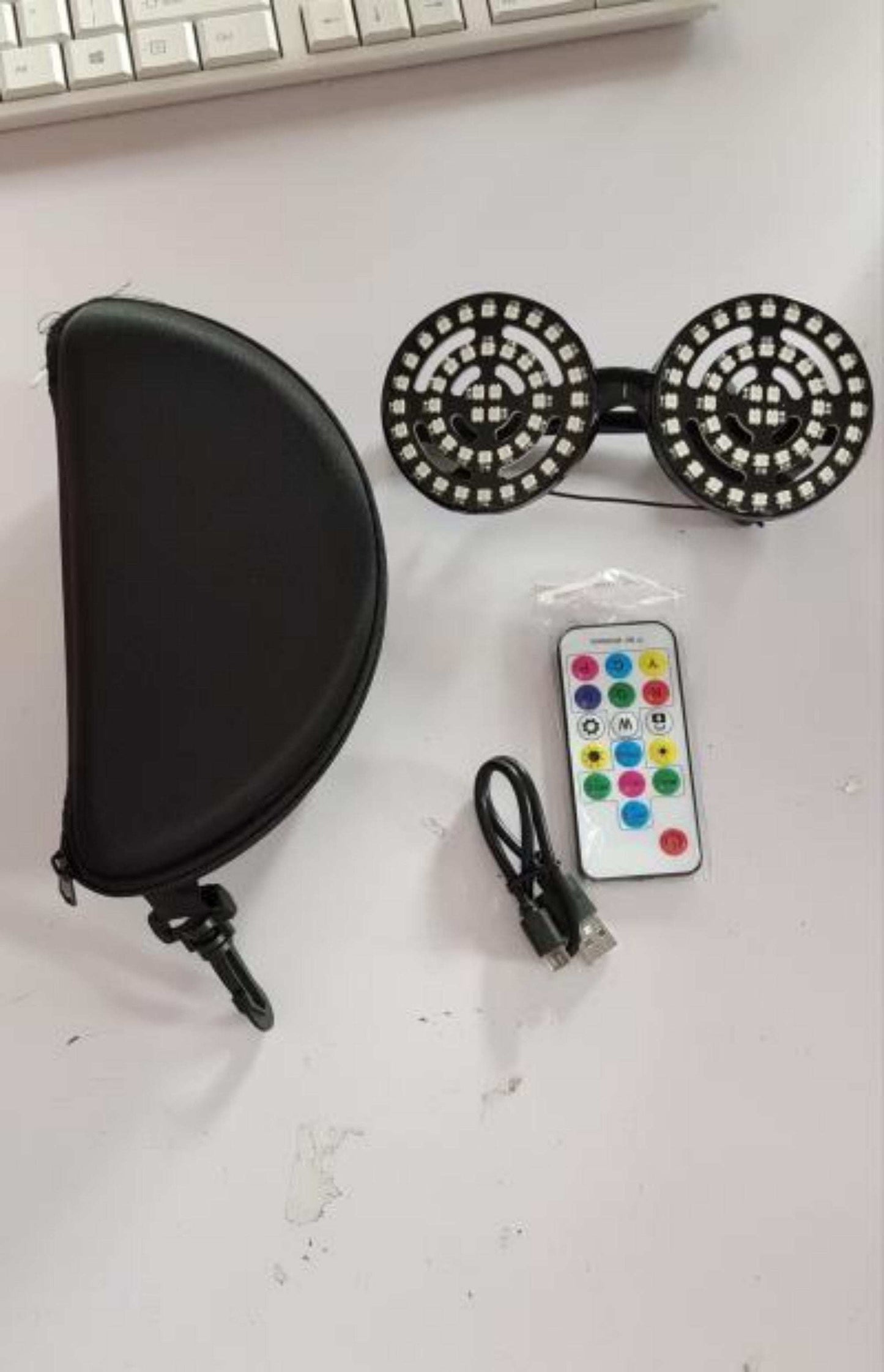 Rezonator goggles with luminous glasses, USB charging cable, remote control, and case.