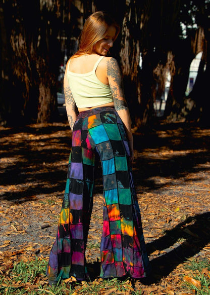 Handcrafted fairtrade palazzo pants with vibrant patterns in a forest setting.