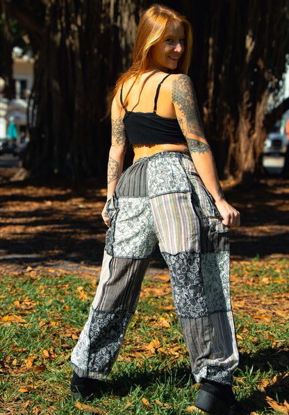 Flora Pants with mushroom pattern and patchwork design in outdoor setting.