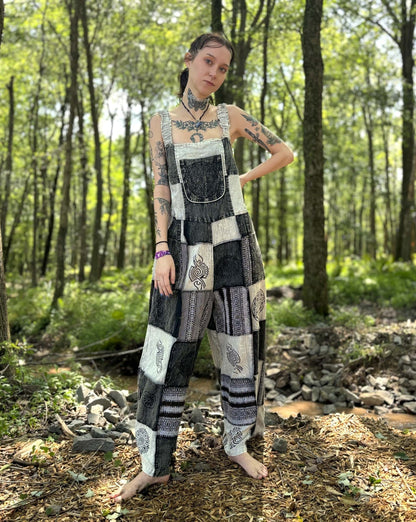 Black & White Patchwork Overalls with unique hand-printed patches and adjustable straps, featuring a palazzo leg design in a forest setting.