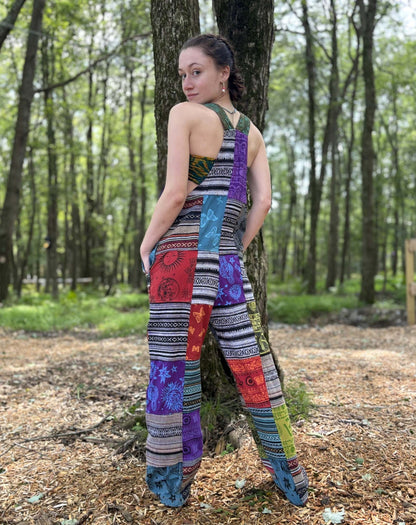 Multi Color & Ikat Patchwork Overalls with adjustable straps in a forest setting.