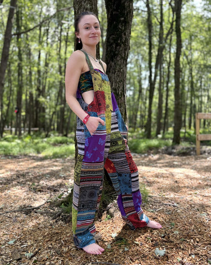 Multi Color & Ikat Patchwork Overalls with vibrant print in a forest setting.