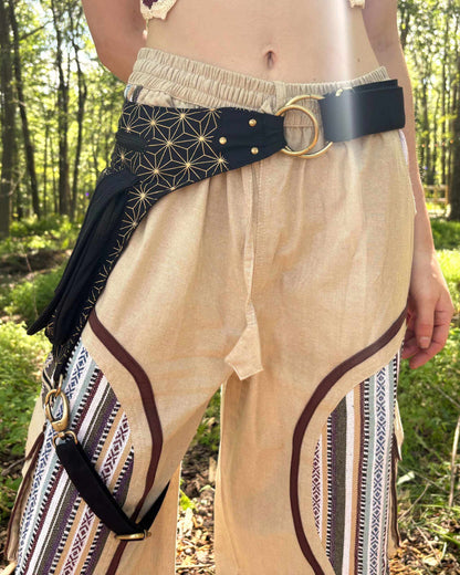 Festival-ready black leg harness belt bag with metal embellishments on pocket, crafted from fair trade cotton.