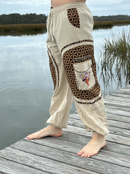 Hippie mushroom harem pants with embroidered flower pattern, handwoven cotton, by lake.