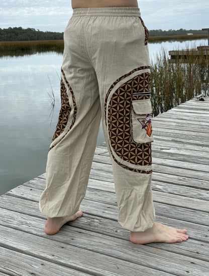 Hippie flower pattern mushroom harem pants on wooden dock near water.