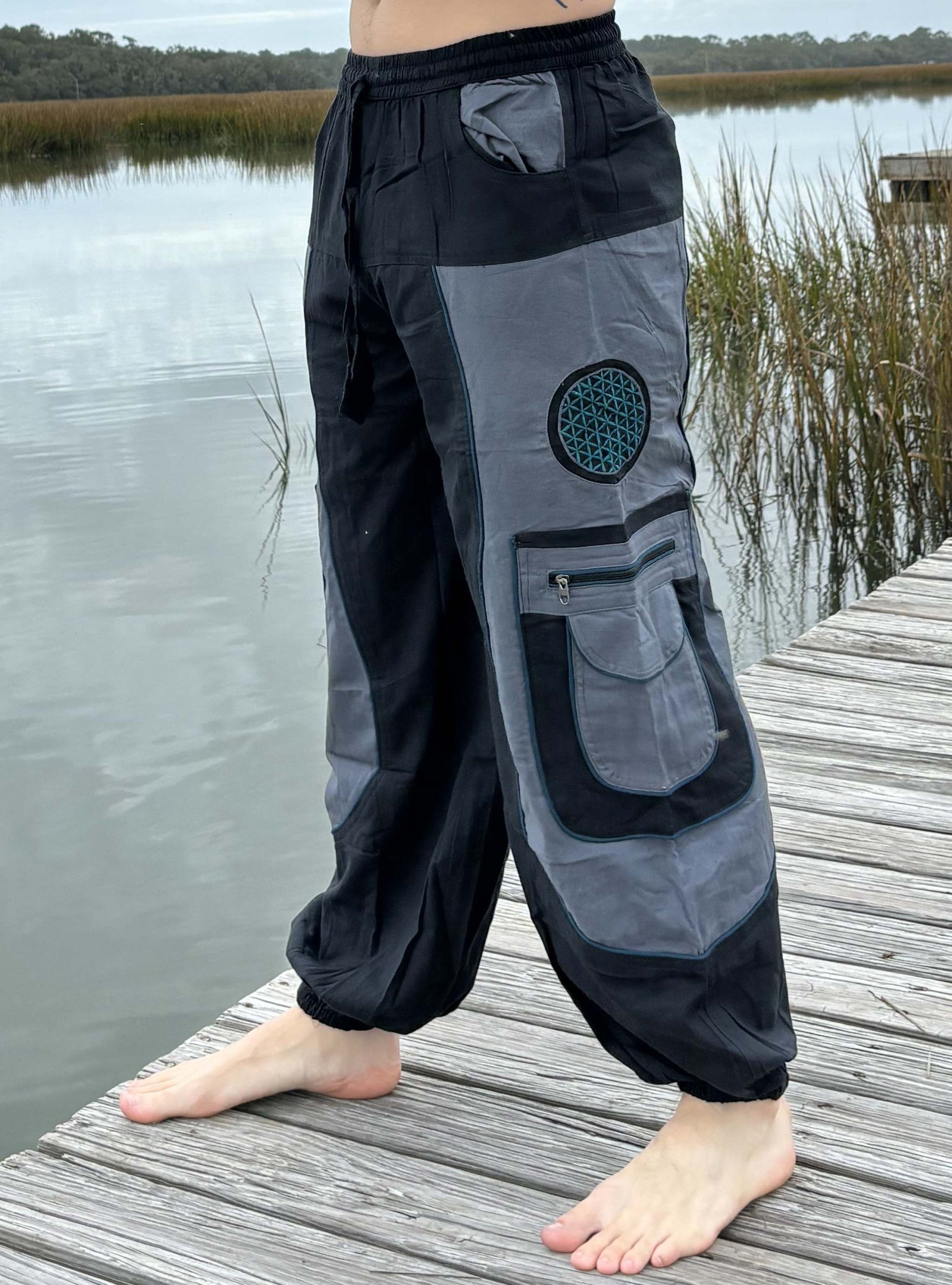 9 pocket harem pants with zipper pockets and elastic cuffs on dock.