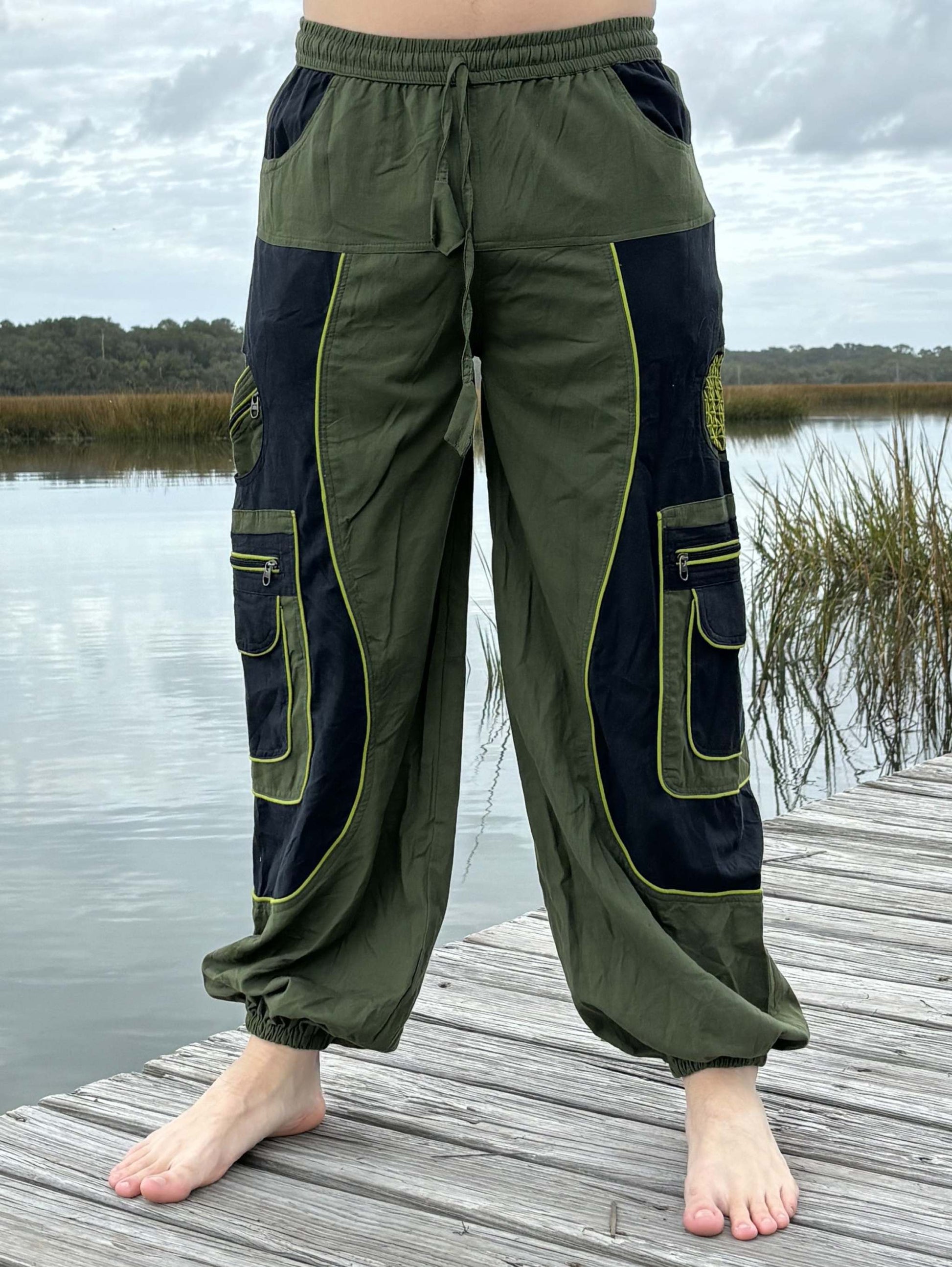 9 pocket harem pants with zipper pockets and elastic cuffs in green and black design.