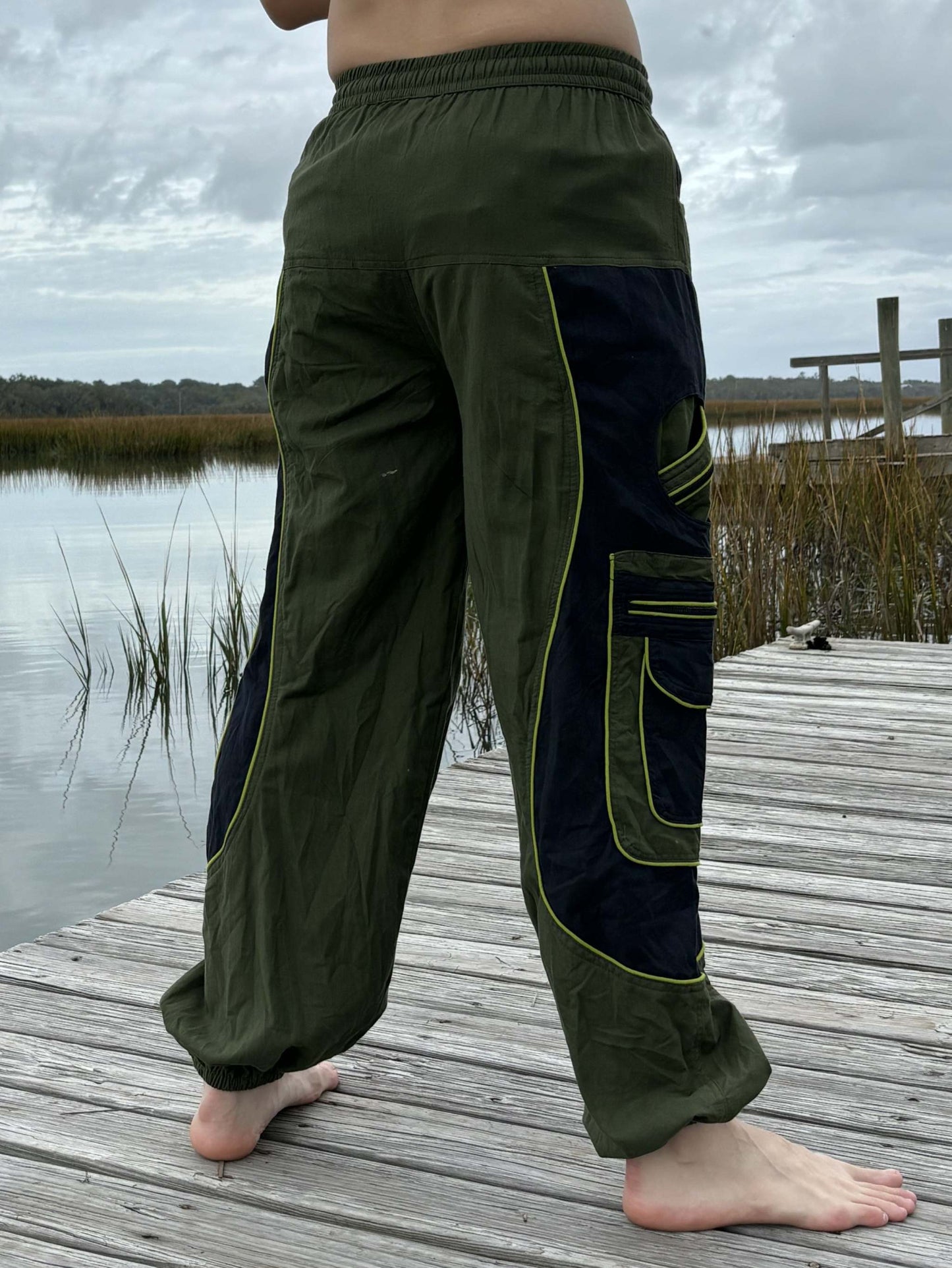 9 pocket harem pants with elastic cuffs and waist, featuring zipper pockets for secure storage.