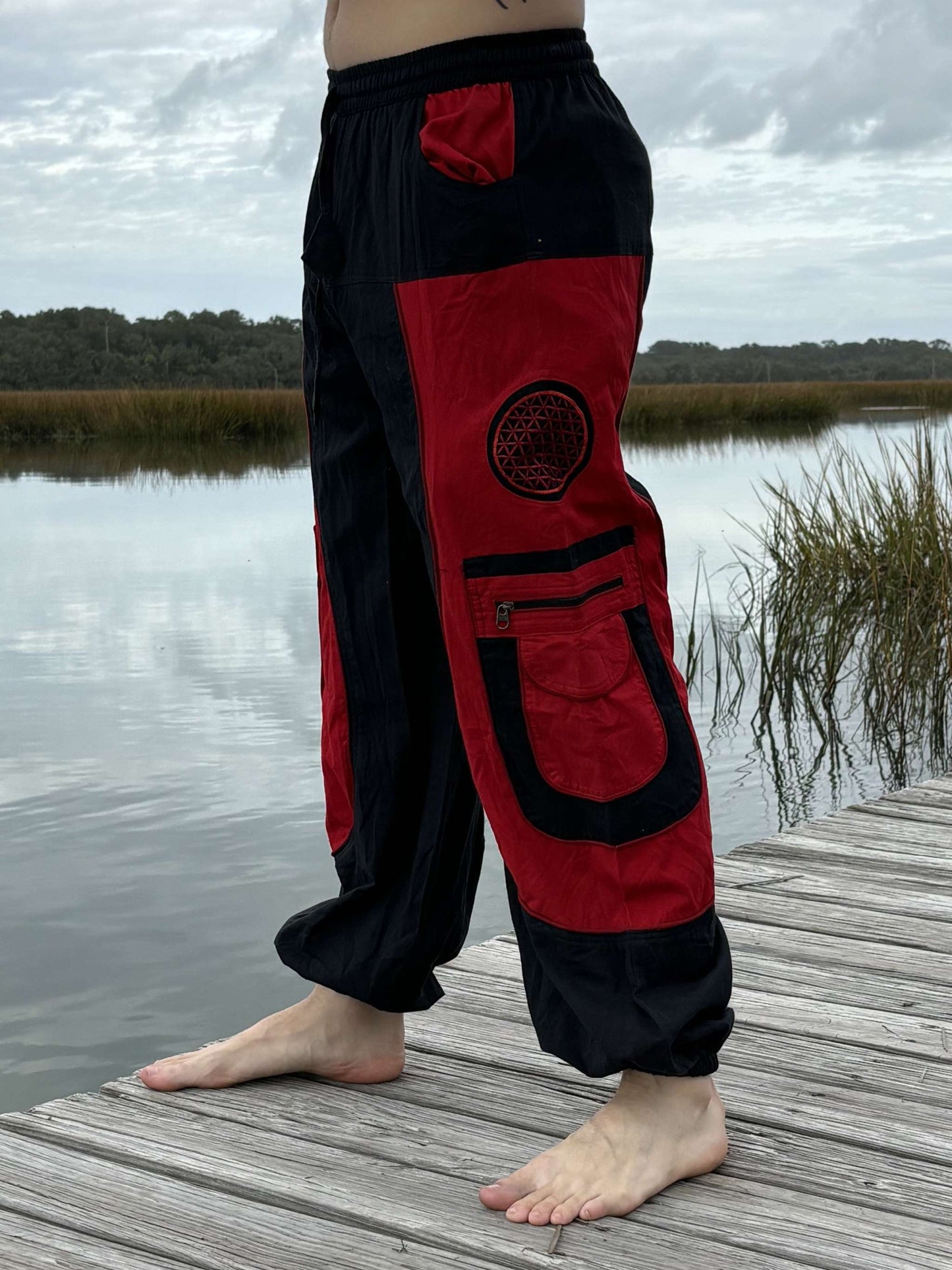 Unisex black and red 9 pocket harem pants with elastic waist and cuffs, ideal for secure storage and stylish comfort.