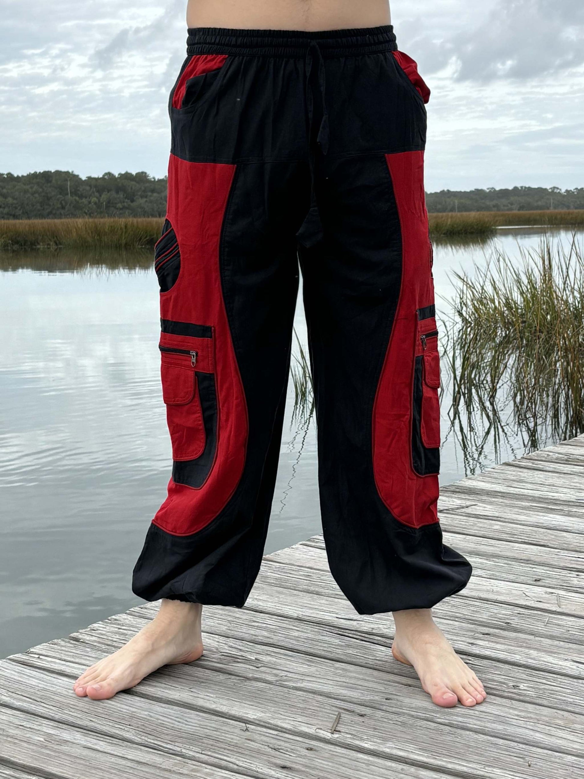 9 pocket harem pants with elastic waist and cuffs, featuring three zipper pockets, in black and red design, ideal for men and women.