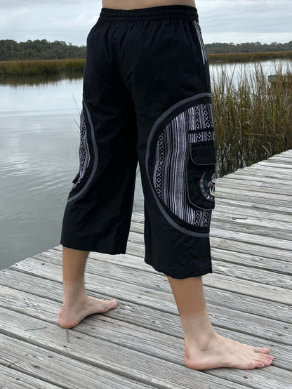 3/4 Mushroom shorts- IKAT, 100% cotton, Fairtrade, designed in America, black with ikat pattern, modeled outdoors.