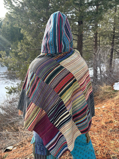 Fairtrade Cotton Patchwork Poncho with hood, featuring colorful designs and wooden toggle buttons, handmade in Nepal.