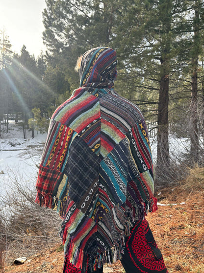 Colorful fleece patchwork poncho in a snowy forest setting.