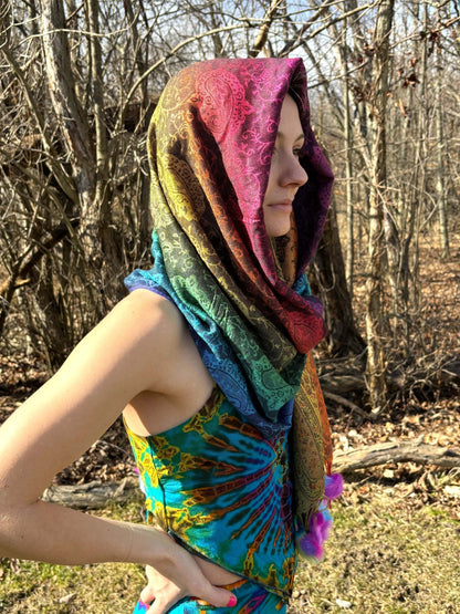 Rainbow Pom-Pom Pashmina outdoors in a wooded area