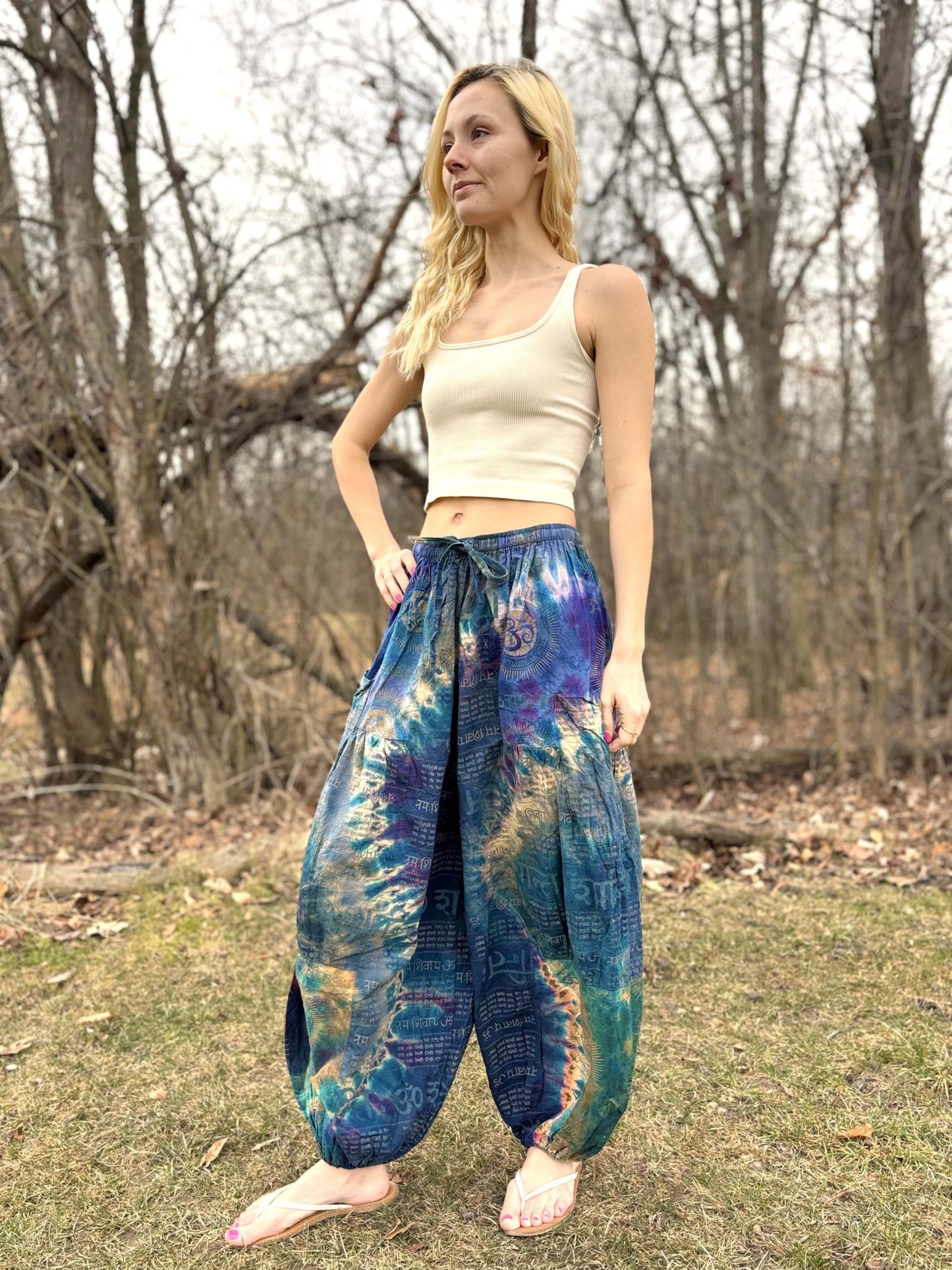 Wide leg Thai Dye Harem pants on model in outdoor setting.