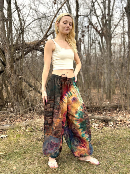Wide leg Thai Dye Harem pants with unique tie-dye pattern, elastic waistband, and ankle cuffs.