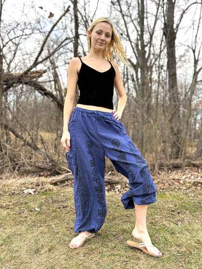 Handmade fair trade cinch leg harem pants in blue cotton, worn outdoors.