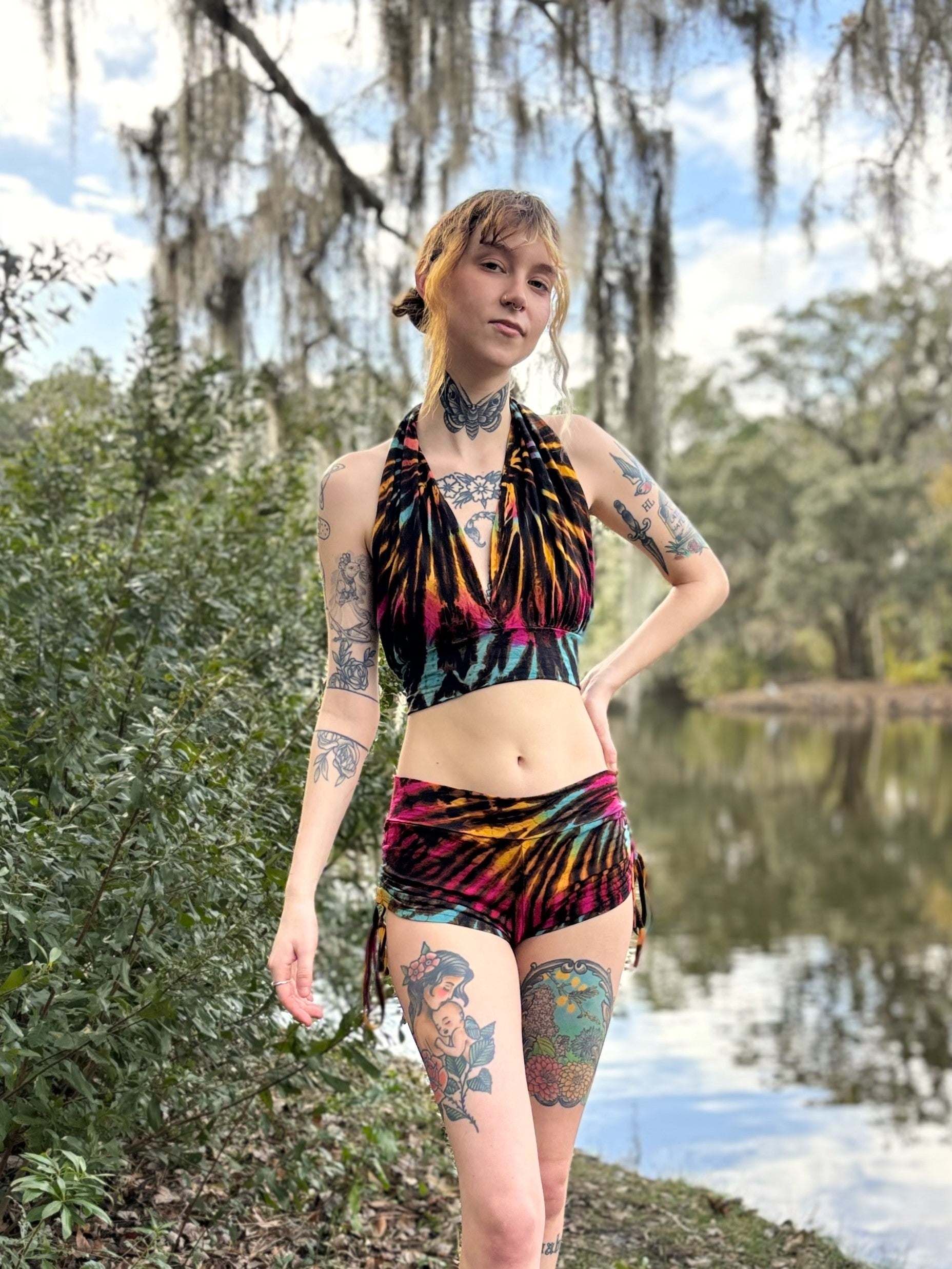 Hand-dyed Monroe top in vibrant colors, fair trade, worn by a model near a lake.