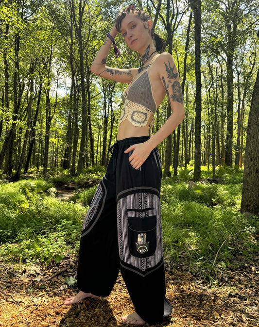 Hamsa Ikat Harem Pants with ethnic ikat pattern worn in a forest setting.